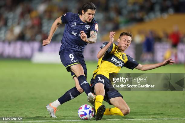 Oskar Zawada of the Phoenix is tackled by Jacob Farrell of the Mariners during the round 18 A-League Men's match between Central Coast Mariners and...