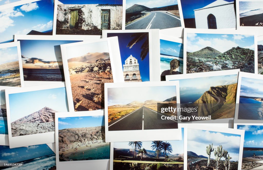Collection of instant film travel photos laid out on a table