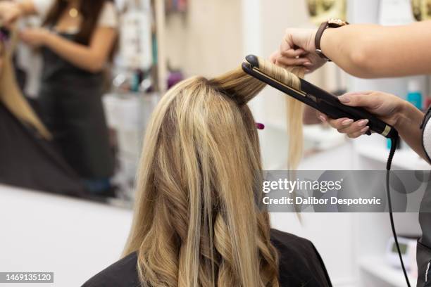 woman getting curls from hairdressers. - compact mirror stockfoto's en -beelden