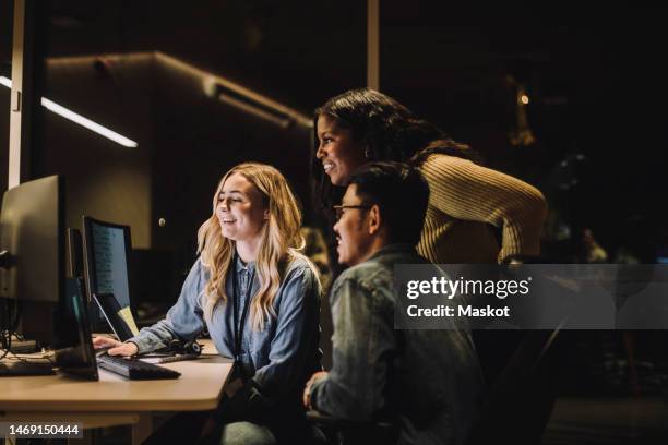 smiling multiracial customer service team looking at computer in call center - customer experience stock pictures, royalty-free photos & images