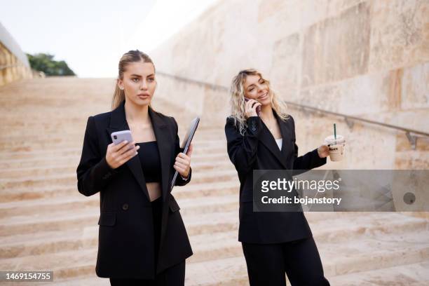 two young businesswomen commuting to work - malta business stock pictures, royalty-free photos & images