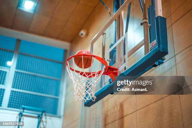 basketball hoop and a basketball ball on it - basketball hoop stockfoto's en -beelden