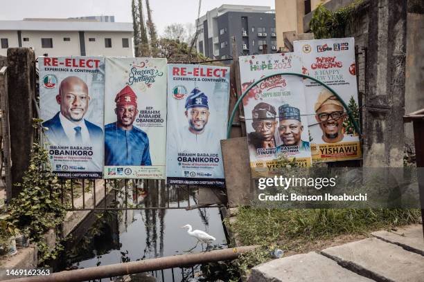 Campaign posters of the All Progressive Congress candidates at a canal in Lagos on February 23, 2023 in Lagos, Nigeria. Nigerians are preparing to...