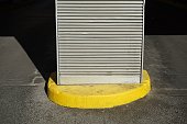 Post in a parking lot, grey asphalt background