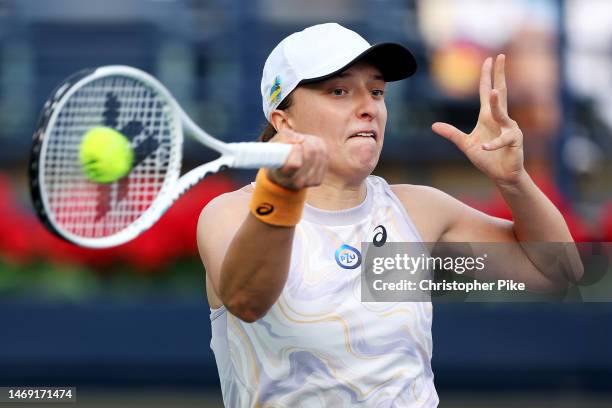 Iga Swiatek of Poland plays a forehand against Coco Gauff of USA during her women's singles semi-final match on day six of the Dubai Duty Free Tennis...