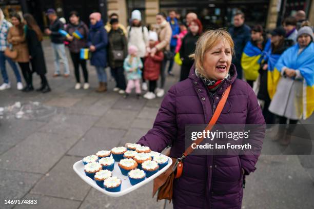 Woman offers home made cakes for sale to raise funds as Northeast Ukrainian Community groups gather at Grey’s Monument in Newcastle-upon-Tyne to mark...