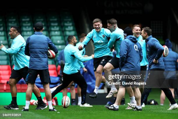 Owen Farrell and Freddie Steward of England share a joke during the England Captain's Run at Principality Stadium on February 24, 2023 in Cardiff,...