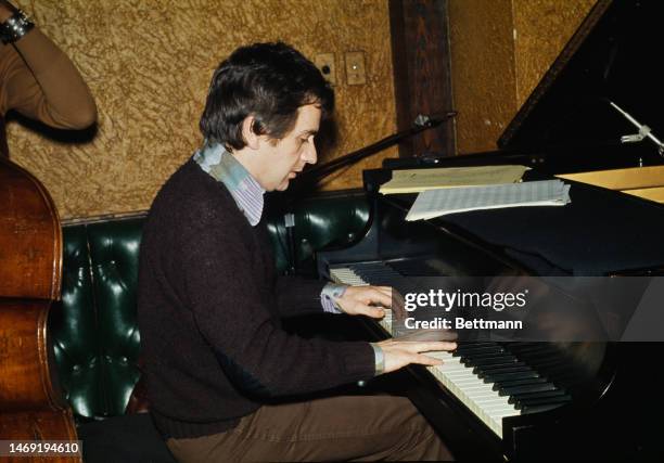 British actor and musician Dudley Moore plays the piano at the grand opening of Michael's Pub in New York City on February 26, 1974.