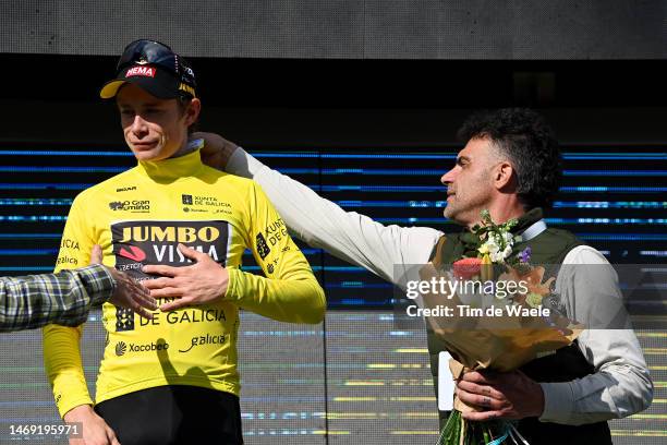 Jonas Vingegaard of Denmark and Team Jumbo-Visma celebrates at podium as Yellow Leader Jersey winner accompanied by Oscar Pereiro of Spain Ex...