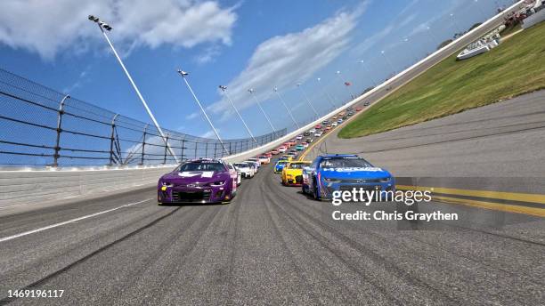 Alex Bowman, driver of the Ally Chevrolet, and Kyle Larson, driver of the HendrickCars.com Chevrolet, lead the field on a pace lap prior to the...