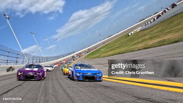 Alex Bowman, driver of the Ally Chevrolet, and Kyle Larson, driver of the HendrickCars.com Chevrolet, lead the field on a pace lap prior to the...