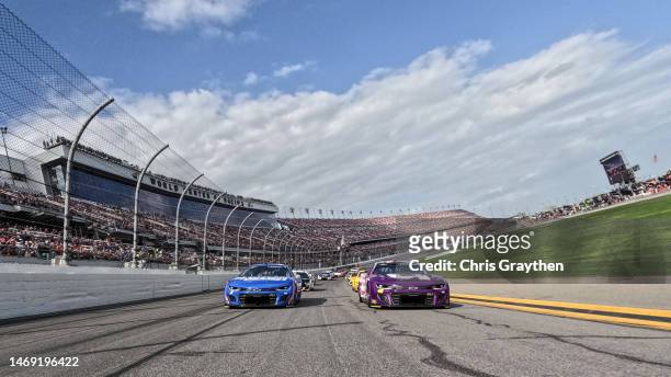 Alex Bowman, driver of the Ally Chevrolet, and Kyle Larson, driver of the HendrickCars.com Chevrolet, lead the field on a pace lap prior to the...