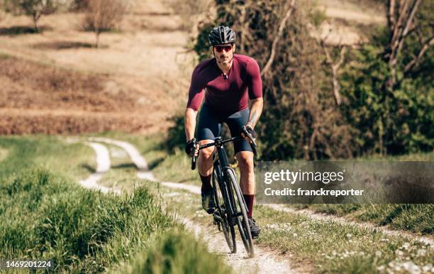 man riding on the gravel bike - white gravel stock pictures, royalty-free photos & images