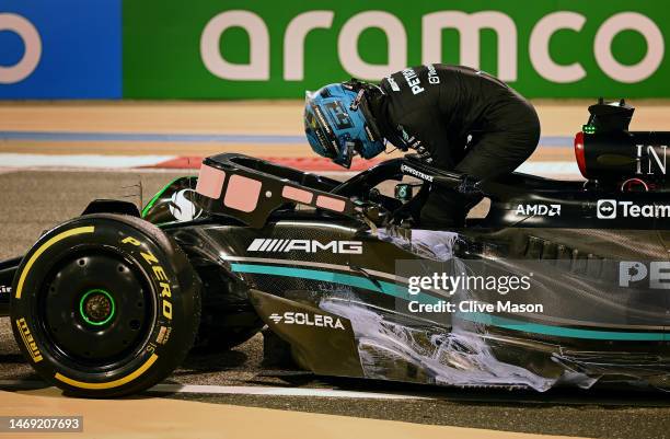 George Russell of Great Britain and Mercedes climbs from his car after stopping on track during day two of F1 Testing at Bahrain International...