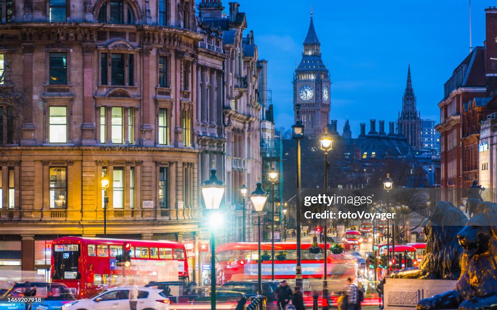 London Big Ben overlooking Whitehall red buses Trafalgar Square night