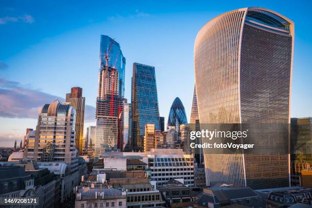 city of london financial district skyscrapers soaring over rooftops sunset - square mile stock pictures, royalty-free photos & images