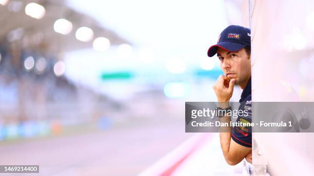 Sergio Perez of Mexico and Oracle Red Bull Racing watches the action on track from the pit wall during day two of F1 Testing at Bahrain International...