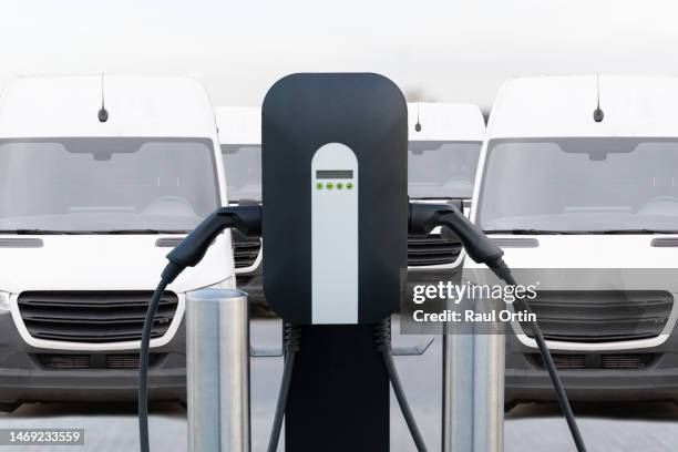 electric commercial vehicles recharging at charging station. - electricity stock pictures, royalty-free photos & images