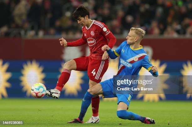 Ao Tanaka of Duesseldorf is challenged by Saulo Igor Decarli of Braunschweig during the Second Bundesliga match between Fortuna Düsseldorf and...