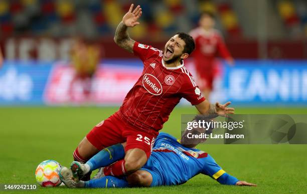 Matthias Zimmermann of Duesseldorf is challenged by Niko Kijewski of Braunschweig during the Second Bundesliga match between Fortuna Düsseldorf and...