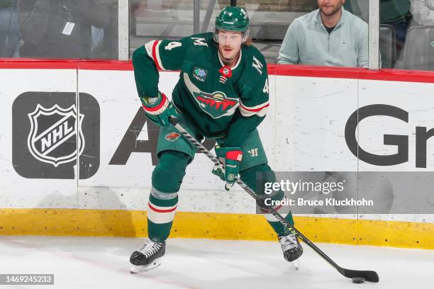 Jon Merrill of the Minnesota Wild handles the puck against the Nashville Predators during the game at the Xcel Energy Center on February 19, 2023 in...