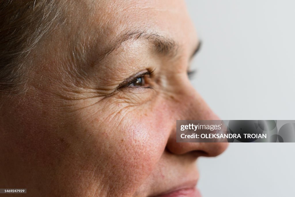 Close-up of middle age woman face with wrinkles, profile view
