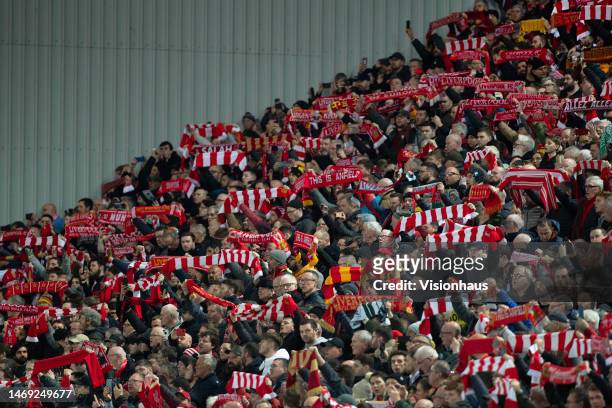 Liverpool fans wave scarves before the UEFA Champions League round of 16 leg one match between Liverpool FC and Real Madrid at Anfield on February...
