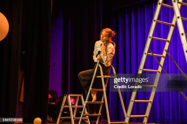 young female actor on stage during the performance - acteren stockfoto's en -beelden