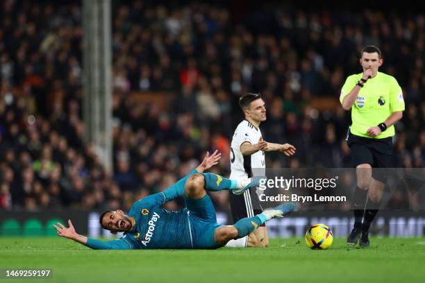 Matheus Cunha of Wolverhampton Wanderers is fouled by Joao Palhinha of Fulham during the Premier League match between Fulham FC and Wolverhampton...