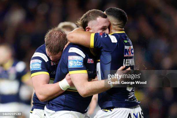 Cameron Smith of Leeds Rhinos celebrates with teammates after scoring the team's first try during the Betfred Super League match between Leeds Rhinos...