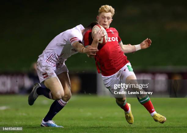 Harri Houston of Wales is tackled by Tobias Elliot of England during the U20 Six Nations Rugby match between Wales and England at Stadiwm CSM on...