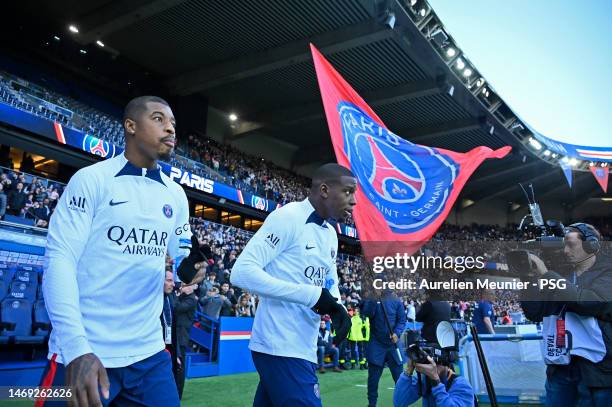 Presnel Kimpembe and Nordi Mukiele arrive on the pitch for a Paris Saint-Germain training session at Parc des Princes on February 24, 2023 in Paris,...