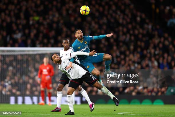 Matheus Cunha of Wolverhampton Wanderers battles for possession with Kenny Tete of Fulham during the Premier League match between Fulham FC and...