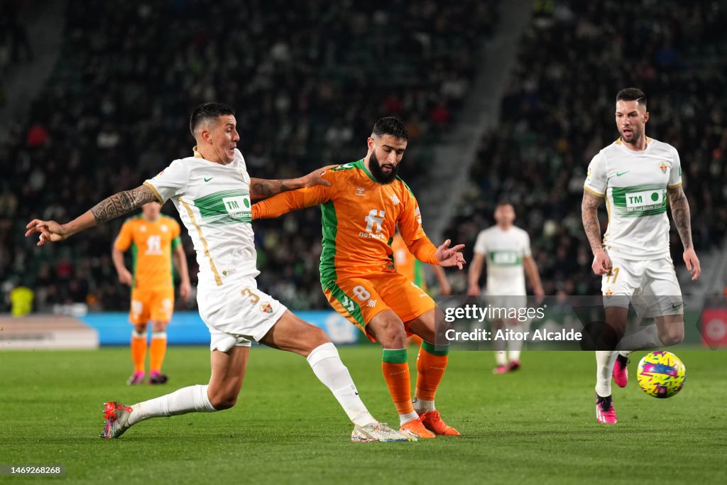 Enzo Roco Enzo Roco of Elche CF passes the ball while under pressure from Nabil ...