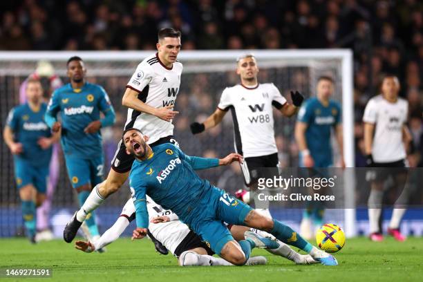 Matheus Cunha of Wolverhampton Wanderers is tackled by Sada Lukic of Fulham during the Premier League match between Fulham FC and Wolverhampton...