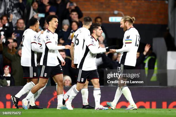 Manor Solomon of Fulham celebrates with teammates after scoring the team's first goal during the Premier League match between Fulham FC and...