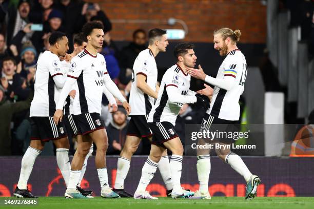 Manor Solomon of Fulham celebrates with teammates after scoring the team's first goal during the Premier League match between Fulham FC and...