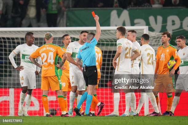 Referee David Iglesias Gutierrez shows a red card to Lisandro Magallan of Elche CF during the LaLiga Santander match between Elche CF and Real Betis...