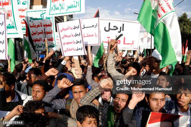 Yemeni protestors loyal to the Houthi group chant slogans as they participate in a demonstration held against the Israeli recent Wednesday raids that...