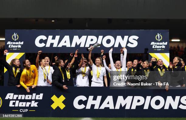 Leah Williamson of England lifts the Arnold Clark Cup with her team mates following the Arnold Clark Cup match between England and Belgium at Ashton...