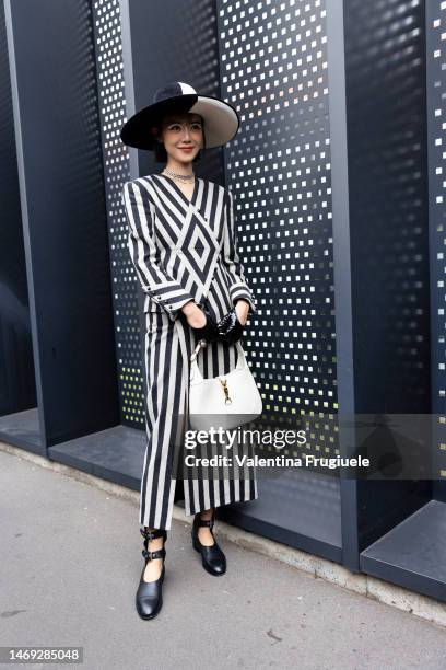 Elva Ni is seen wearing a geometrical striped black and white dress, Gucci letter neckless, wide-brimmed black and white hat, Gucci Jackie 1961 bag...