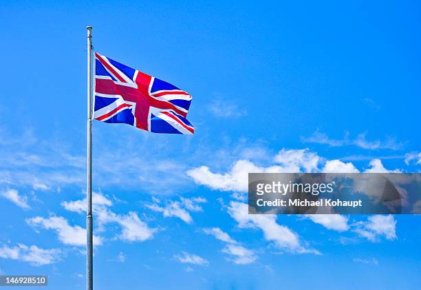 waving flag of great britain - bandiera inglese foto e immagini stock