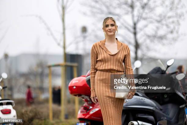 Valentina Ferragni is seen wearing silver and gold Valentina Ferragni earrings, rings and bracelets, a beige striped coord-set made of a V-neck shirt...