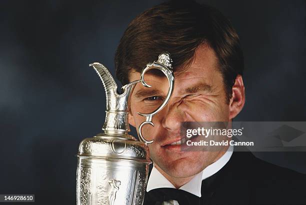 Portrait of Nick Faldo holding the Claret trophy for becoming British Open Champion in 1990 on 1st December 1990 in London, England.