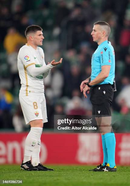 Guti of Elche CF speaks with Referee David Iglesias Gutierrez during the LaLiga Santander match between Elche CF and Real Betis at Estadio Manuel...