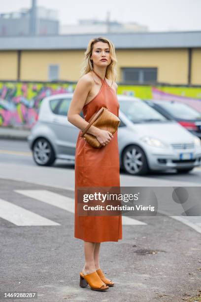 Chloe Lecareux wears brown dress, bag, sandals outside Tods during the Milan Fashion Week Womenswear Fall/Winter 2023/2024 on February 24, 2023 in...