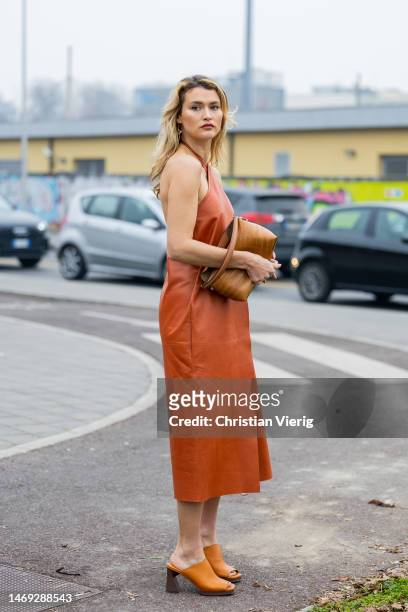 Chloe Lecareux wears brown dress, bag, sandals outside Tods during the Milan Fashion Week Womenswear Fall/Winter 2023/2024 on February 24, 2023 in...