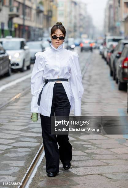 Guest wears white blouse, black pants outside Sportmax during the Milan Fashion Week Womenswear Fall/Winter 2023/2024 on February 24, 2023 in Milan,...