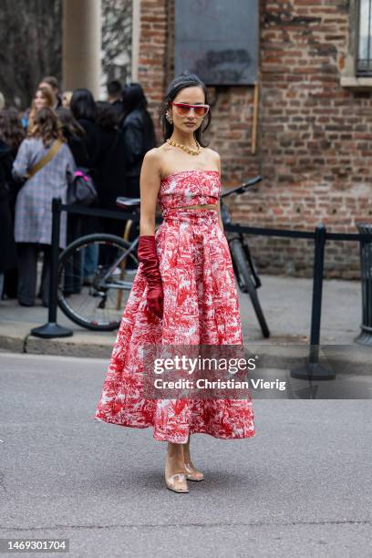 Anna Rosa Vitiello wears red off shoulder dress, gloves, plexiglas heels outside Philosophy during the Milan Fashion Week Womenswear Fall/Winter...