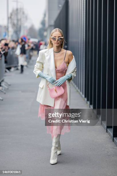 Leonie Hanne wears white blazer, pink laced transparent dress, bag, gloves, laced boots outside Gucci during the Milan Fashion Week Womenswear...